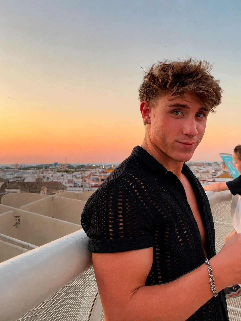 Cameron on a rooftop at sunset.